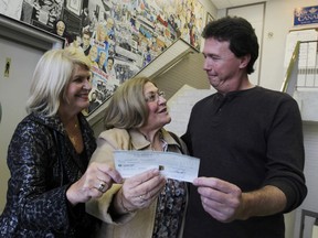 In this file photo from left is Vera Drude  and Mary Bondy from the  Windsor-Essex  chapter of the Sunshine Dreams for Kids,  accept a cheque from Chris Taylor, president of CAW Local 200 on Friday October 28, 2011 in Windsor, Ontario.  Eight local charities shared more than $40,000 in funds raised during the Frank McAnally Golf Tournament.(JASON KRYK/ The Windsor Star)