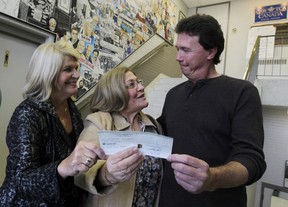 In this file photo from left is Vera Drude  and Mary Bondy from the  Windsor-Essex  chapter of the Sunshine Dreams for Kids,  accept a cheque from Chris Taylor, president of CAW Local 200 on Friday October 28, 2011 in Windsor, Ontario.  Eight local charities shared more than $40,000 in funds raised during the Frank McAnally Golf Tournament.(JASON KRYK/ The Windsor Star)