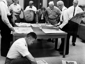 Sept. 9, 1965: Department heads look over the early editions of The Star. Shown standing are editor W.L. “Lum” Clark, left, composing room foreman Don Bell, engraving foreman Fred Black, general manager Richard Graybiel, press foreman Tom Crowley,  publisher Hugh Graybiel and executive editor Norm Hull. In the foreground is advertising director Bill Viveash. (Windsor Star files)