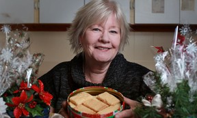 Colleen Campbell, from Stoney Point, displays a tin of her shortbread cookies that she sells in gift shops and to companies and individuals who buy them for gift giving, Tuesday, Nov. 20, 2012.  (DAX MELMER/The Windsor Star)