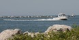 A police boat searches for bodies near a submerged boat Monday June 6, 2011, near the Leamington Marina in Leamington, Ont. Three people are missing after the boat struck a breakwall late Sunday evening. (DAN JANISSE/The Windsor Star)