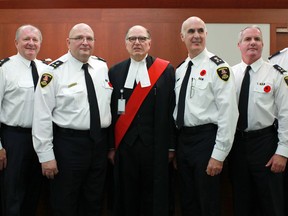 From left, Inspector Tom Crowley, Deputy Chief Jerome Brannagan, Deputy Chief of Operational Support Rick Derus, Ontario Court Justice Guy DeMarco, Windsor Police Chief Al Frederick, Deputy Chief of Operations Vince Power, and Superintendent Michael Langlois are pictured at the swearing in of Deputy Chief of Operational Support, Rick Derus, at the Ontario Court of Justice in downtown Windsor, Nov. 5, 2012.  (DAX MELMER/The Windsor Star)
