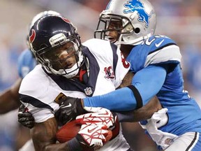 Houston's Andre Johnson, left, is tackled by Detroit's Chris Houston at Ford Field on November 22, 2012 in Detroit, Michigan. Houston won 34-31. (Photo by Gregory Shamus/Getty Images)