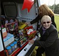 Shirley Beaton, from Windsor Homes Coalition  at front, and Holly Burt, president of the Children's Aid Foundation, and  look over a stash of toys and food at the Windsor Police collision reporting centre in Windsor on November 8, 2012. (TYLER BROWNBRIDGE / The Windsor Star)