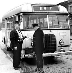 Scenes like this were enacted several times yesterday and today on the route of Erie buses as police took drivers names and addresses and warned them that they were violating the law by operating buses while an application for a court order to prevent bus operation on the line is pending. Operator Joseph Knapp who drove No.1 bus is seen showing his driver's licence to Constable Ed. "Spanky" MacFarlane. (The Windsor Star-FILE)