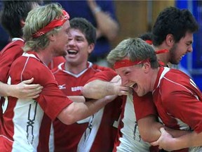 Essex's Mitch Taveirne, left, Jacob Taveirne, right, and Cameron Branch celebrate after winning the SWOSSAA volleyball championship against Walkerville Tuesday, Nov. 13, 2012,  in Windsor, Ont. (DAN JANISSE/The Windsor Star)