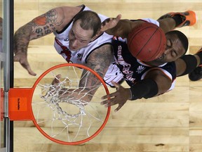 Windsor's Wayne Portalatin, left, battles Summerside's Brandon Hassell for a rebound in the second quarter of NBL action between the Windsor Express and the Summerside Storm at the WFCU Centre, Sunday, Nov. 18, 2012.  Windsor won 97-93. (DAX MELMER/The Windsor Star)