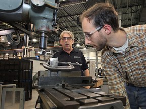 St. Clair College instructor Gary Steed (L) teaches apprentice Ryan Solcz techniques on a vertical mill machine, Wednesday, Nov. 14, 2012, at the Windsor, Ont. school. According to several local companies there is a lack of skilled trades workers in the area.   (DAN JANISSE/The Windsor Star)