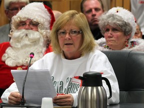 Maggie Durocher of the Windsor Parade Corporation speaks to City Council as Santa Claus and Jessica Mary Claus, right, listen to the discussion concerning DWBIA 2012 Winter Fest and parade Monday November 19,  2012.  (NICK BRANCACCIO/The Windsor Star)