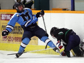 Massey Mustangs Jacob Hennin, left, battles with E. J. Lajeunesse forward Nathan Ducharme in boys high school hockey at South Windsor Arena Monday November 26, 2012.