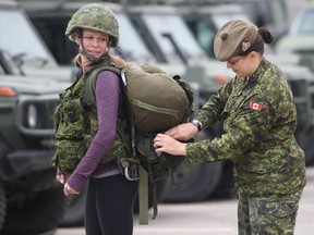 Windsor star reporter Kelly Steele completes a workout with Master Corporal Renee Mitchell at the Tilston Armoury on November 23, 2012. (JASON KRYK/ The Windsor Star)