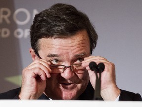 For the fiscal year 2014-15, federal Finanace Minister Jim Flaherty, shown here, predicts a deficit of $5.5 billion for 35 million people. Yet, Ontario Finance Minister Charles Sousa says the provincial deficit will be $10.1 billion for the same year for 13.5 million citizens. (THE CANADIAN PRESS/Michelle Siu )