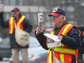 Goodfellows volunteer Don Urban (R) and Bob Parent sell the annual Christmas edition newspapers Thursday, Nov. 24, 2011, at the intersection of Ouellette Ave and Tecumseh Rd.  (DAN JANISSE/The Windsor Star)