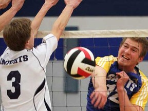 St. Anne's Greg Mullins, right, spikes the ball against Holy Names' Philip Sax during the WECSSAA volleyball championship November 08, 2012.  (NICK BRANCACCIO/The Windsor Star)