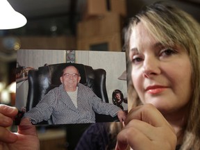 Lisa Joseph is suing Heron Terrace long-term care home for the wrongful death of her father, who died choking after being served the wrong food. She wants the case to set a precedent and bring about concrete changes, namely using wristbands like in hospitals, which specify peoples' dietary restrictions. She poses with a photo of her father Michael Ellis Joseph, Tuesday, Nov. 27, 2012, at her Lakeshore, Ont. residence. (DAN JANISSE/The Windsor Star)