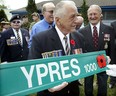 Second World War veteran Stan Scislowski, 81, formerly of the Perth Regiment of the Canadian Army, holds a new Ypres street sign designated with a poppy to remember the brave Canadian soldiers who paid the ultimate price. Scislowski himself was injured while carrying a wounded soldier from the battefields of Italy during the Second World War.  Windsor Mayor Eddie Francis and city councillors joined with veterans and current members of the Armed Forces during a brief ceremony on Ypres Avenue and Forest Avenue on May 11, 2005 The ceremony marked the official start to local VE Day celebrations and the public is invited to attend the Old Armoury on University Avenue East for a historical display.  (Windsor Star files)