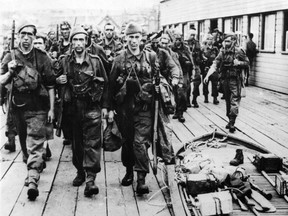 The Raiders are Back from Dieppe. Grim, black-faced and tired, these Allied soldiers march along the dock after returing from Dieppe following the Combined Operations raid there. Their back at their home base--A southern English port--And are looking forward to a hot mug of coffee and lots of rest after their successful destruction of enemy fortifications. (Windsor Star archives)