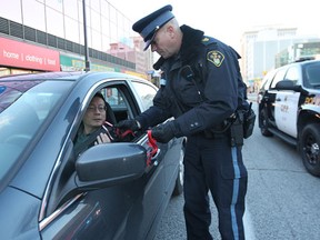 Officers with the Windsor Police Service, Lasalle Police and Ontario Provincial Police along with the local MADD chapter kicked off an awareness campaign Thursday, Nov. 1, 2012, in downtown Windsor, Ont. They were reminding people not to drink and drive. A ride check point was set up in Ouellette Ave. Here officers with the three local police services pose for a photo prior to the start of the ride check.   (DAN JANISSE/The Windsor Star