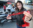 Officers with the Windsor Police Service, Lasalle Police and Ontario Provincial Police along with the local MADD chapter kicked off an awareness campaign Thursday, Nov. 1, 2012, in downtown Windsor, Ont. They were reminding people not to drink and drive. A ride check point was set up in Ouellette Ave. Nina Zajac of the MADD chapter displays a red ribbon during the event.   (DAN JANISSE/The Windsor Star)