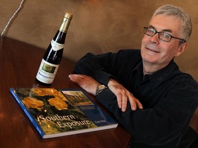 Gary May, author of Southern Exposure, poses with his book and an original Pelee Island icewine from 1983. (TYLER BROWNBRIDGE / The Windsor Star)