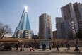 file photo, the sun is reflected from the top of the 105-story Ryugyong Hotel, which remains under construction, in Pyongyang, North Korea. International hotel operator Kempinski AG said Thursday, Nov. 1, 2012 it will manage the pyramid-shaped hotel that is expected to open next year with shops, offices, ball rooms and restaurants and 150 rooms. (AP Photo/David Guttenfelder)