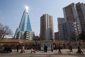 file photo, the sun is reflected from the top of the 105-story Ryugyong Hotel, which remains under construction, in Pyongyang, North Korea. International hotel operator Kempinski AG said Thursday, Nov. 1, 2012 it will manage the pyramid-shaped hotel that is expected to open next year with shops, offices, ball rooms and restaurants and 150 rooms. (AP Photo/David Guttenfelder)