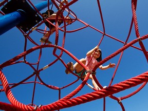 Children climb on the play equipment at a schooll in Victoria, B.C. August 11, 2011. (Postmedia News files)