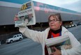 Sue Paulton, an Anglican priest with St. Marks and St. David's Anglican churches in Windsor, help raise money for the Postmedia Raise-a-Reader campaign, outside of the Windsor Assembly Plant, Thursday, Sept. 20, 2012.  (DAX MELMER/The Windsor Star)