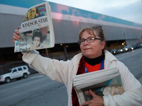 Sue Paulton, an Anglican priest with St. Marks and St. David's Anglican churches in Windsor, help raise money for the Postmedia Raise-a-Reader campaign, outside of the Windsor Assembly Plant, Thursday, Sept. 20, 2012.  (DAX MELMER/The Windsor Star)