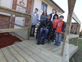 Alex Rocha , centre, poses with his family (l to R), Ethan, Melissa, Devlin, Braden, and Cameron at their Windsor home on November 16, 2012.  The carpenters Local 494 has donated time and money towards the construction of the wheelchair ramp for Alex Rocha.  Rocha is recovering from  recent brain surgery. (JASON KRYK/ The Windsor Star)