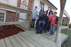 Alex Rocha , centre, poses with his family (l to R), Ethan, Melissa, Devlin, Braden, and Cameron at their Windsor home on November 16, 2012.  The carpenters Local 494 has donated time and money towards the construction of the wheelchair ramp for Alex Rocha.  Rocha is recovering from  recent brain surgery. (JASON KRYK/ The Windsor Star)