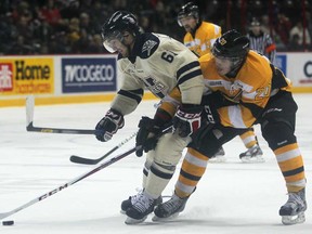 Windsor's Chris Marchese, left, battles Kingston's Roland McKeown for the puck at the WFCU Centre, Sunday, Nov. 25, 2012. The Frontenacs beat the Spitfires 4-3. (DAX MELMER/The Windsor Star)