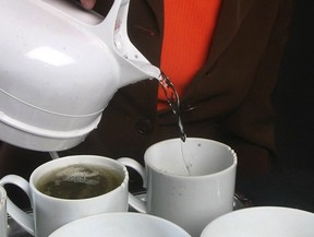 File photo of a woman pouring hot water on to a tea bag. (Postmedia News files)