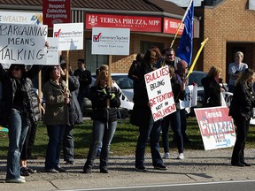 A group of teachers and supporters protest in front of Teresa Piruzza's office in WIndsor on Friday, November 16, 2012.                 (TYLER BROWNBRIDGE / The Windsor Star)