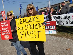 A group of teachers and supporters protest in front of Teresa Piruzza's office in WIndsor on Friday, November 16, 2012.                 (TYLER BROWNBRIDGE / The Windsor Star)