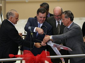 From left, Ghassan Jafar, Dwight Duncan, Gary McNamara and Dr. Fouad Tayfour cut a ribbon during the grand opening of the Tecumseh Manning Medical Centre in Tecumseh on Friday, November 23, 2012. (TYLER BROWNBRIDGE / The Windsor Star)