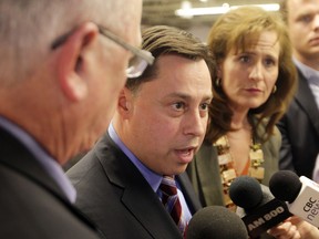 Brad Duguid, centre, Ontario Minister of Energy in this file photo, speaks at press conference announcing the  $12 million  investment by United Solar in a manufacturing facility in LaSalle, (JASON KRYK/ The Windsor Star)