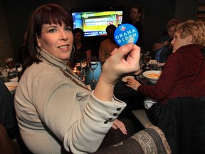 Shelley Sharpe, a member of an American expat group called Democrats Abroad displays an Obama/Biden pin at a gathering Tuesday, Nov. 6, 2012, at the City Grill in Windsor, Ont. A handful of members gathered to watch the results of the U.S. elections.  (DAN JANISSE/The Windsor Star)