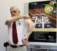 Medical officer of health, Dr. Allen Heimann, rolls up his sleeve to receive a flu shot during a news conference in September at which he announced flu vaccines are readily available.  Everyone except those with certain medical conditions should get the vaccine, he said.   (NICK BRANCACCIO/ Windsor Star file)