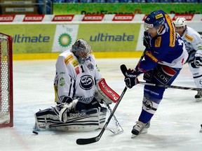 In this picture made available Sunday Dec. 2, 2012. Kloten Flyers  Brooks Laich, right, challenges with HC Ambri-Piotta goalie  Nolan Schaefer, right, during a Swiss hockey League A match between Kloten Flyers and HC Ambri-Piotta  in Kloten, Switzerland Saturday Dec. 1, 2012. Due to the NHL lockout, Laich,  of  Washington Capitals, plays in Kloten, Switzerland. (AP Photo/Keystone/Patrick B. Kraemer)