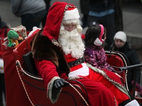 Santa Claus waves to the crowd while making his way down Ouellette Avenue in the Holiday Parade in downtown Windsor, Saturday, Dec. 15, 2012.  (DAX MELMER/The Windsor Star)