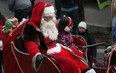 Santa Claus waves to the crowd while making his way down Ouellette Avenue in the Holiday Parade in downtown Windsor, Saturday, Dec. 15, 2012.  (DAX MELMER/The Windsor Star)