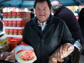 Past president of the Canadian Italian Business Professional Association, Carl Grossi,  prepares to give out turkey dinners at the CIBPA Christmas turkey donation outside the CIBPA Centre, Saturday, Dec. 22, 2012.  (DAX MELMER/The Windsor Star)