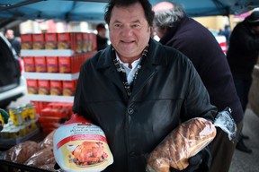 Past president of the Canadian Italian Business Professional Association, Carl Grossi,  prepares to give out turkey dinners at the CIBPA Christmas turkey donation outside the CIBPA Centre, Saturday, Dec. 22, 2012.  (DAX MELMER/The Windsor Star)