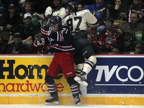 Windsor's Brady Vail gets checked into the boards by Oshawa's Scott Laughton, left, in OHL action between the Windsor Spitfires and the visiting Oshawa Generals at the WFCU Centre, Sunday, Dec. 9, 2012.  Windsor defeated Oshawa 3-2.  (DAX MELMER/The Windsor Star)