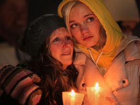 Sally Cartier, left, whose son Norman Cartier died at age 36 in March, stands with her granddaughter, Autumn Cartier, who was Norman's daughter, at the Canadian Mental Health Association Windsor-Essex County Branch's fourth annual Candlelight Service for those bereaved by loss of a child, at the WFCU Centre, Sunday, Dec. 9, 2012.(DAX MELMER/The Windsor Star)