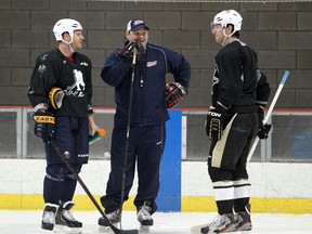 Oshawa Generals head coach D.J. Smith, centre,  talks with NHLers  Steve Ott from the Buffalo Sabres, left, and James Neal from the Pittsburg Penguins during the Oshawa Generals' team workout at the WFCU Centre in Windsor on friday, Dec. 7, 2012. (JASON KRYK/ The Windsor Star)
