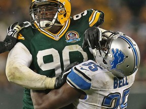 Green Bay's B.J. Raji, left, collides with Detroit's Joique Bell Sunday at Lambeau Field. (Photo by Jonathan Daniel/Getty Images)