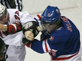 Windsor's Ty Bilcke, left, fights Kitchener's Cory Genovese at the WFCU Centre. (JASON KRYK/ The Windsor Star)