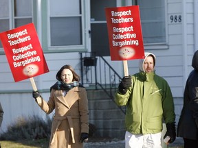 Teachers from David Suzuki Public School catch the attention of passing motorists as they hold a protest on Jefferson Avenue near their school December 12, 2012. (NICK BRANCACCIO/The Windsor Star)